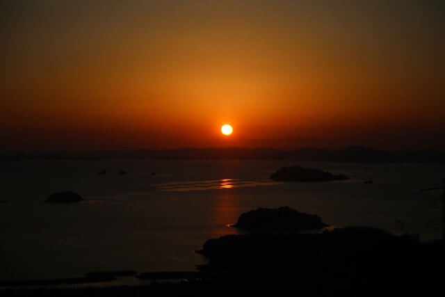 岡山県倉敷市・龍王山から望む瀬戸内海の夕陽。黄金色に輝く海面と、影となって浮かび上がる島々のシルエット。